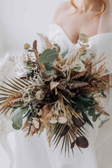 Close up shot of artificial rustic bridal bouquet featuring browns and greens